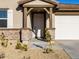 Front entrance with a covered porch, stone accents, and a double door at 22526 W Tonopah Dr, Surprise, AZ 85387