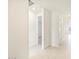 Bright hallway with light tile floors and doors to other rooms at 22526 W Tonopah Dr, Surprise, AZ 85387