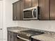 Stainless steel appliances and granite countertops in this modern kitchen at 22526 W Tonopah Dr, Surprise, AZ 85387
