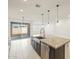 Kitchen island with granite countertops and a farmhouse sink, open to Gathering room at 22526 W Tonopah Dr, Surprise, AZ 85387