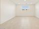 Spacious living room with tile flooring and large window at 22526 W Tonopah Dr, Surprise, AZ 85387