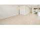 Open living room with tile floors and kitchen access at 22526 W Tonopah Dr, Surprise, AZ 85387