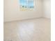 Spacious bedroom with large window and tile floors at 22526 W Tonopah Dr, Surprise, AZ 85387
