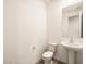 Simple bathroom with white pedestal sink and toilet at 36954 W La Paz St, Maricopa, AZ 85138