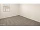 Bright bedroom with carpet flooring and a window with blinds at 36954 W La Paz St, Maricopa, AZ 85138