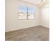 Bright dining room with large window and chandelier at 36954 W La Paz St, Maricopa, AZ 85138