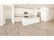 Modern kitchen with island and white cabinets at 36954 W La Paz St, Maricopa, AZ 85138