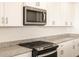 Modern kitchen with stainless steel appliances and granite countertops at 36954 W La Paz St, Maricopa, AZ 85138