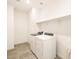 Laundry room with washer, dryer, and overhead shelving at 36954 W La Paz St, Maricopa, AZ 85138