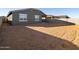 Empty lot backyard with block wall and home view at 37406 W San Clemente St, Maricopa, AZ 85138
