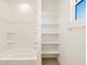 Bathroom with shower, shelves and built-in shelving at 37406 W San Clemente St, Maricopa, AZ 85138
