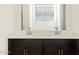 Double sink bathroom with dark brown cabinets and quartz countertops at 37406 W San Clemente St, Maricopa, AZ 85138