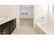Main bathroom with double vanity, tub and view of bedroom at 37406 W San Clemente St, Maricopa, AZ 85138