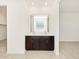 Double vanity bathroom with dark brown cabinets and white countertops at 37406 W San Clemente St, Maricopa, AZ 85138