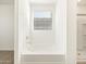 Clean bathroom with a built in tub and window at 37406 W San Clemente St, Maricopa, AZ 85138