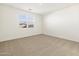 Well-lit bedroom with carpet and window at 37406 W San Clemente St, Maricopa, AZ 85138