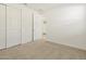 Bright bedroom featuring carpet and double doors to closet at 37406 W San Clemente St, Maricopa, AZ 85138