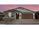 New construction home with gray exterior, brown garage door, and landscaped yard at 37406 W San Clemente St, Maricopa, AZ 85138