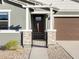 Attractive front entry with stone pillars and an iron gate at 37406 W San Clemente St, Maricopa, AZ 85138