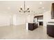 Open concept kitchen with island and breakfast bar at 37406 W San Clemente St, Maricopa, AZ 85138