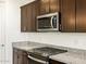 Modern kitchen with stainless steel appliances and granite countertops at 37406 W San Clemente St, Maricopa, AZ 85138