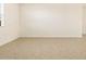 Empty spare bedroom with neutral-toned tile flooring at 37406 W San Clemente St, Maricopa, AZ 85138