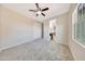 Bedroom with carpeting, a window, a ceiling fan and a bathroom view at 14829 W Pershing St, Surprise, AZ 85379