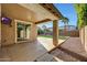 Expansive covered patio with ceiling fan overlooking the large backyard, a perfect outdoor living space at 14829 W Pershing St, Surprise, AZ 85379