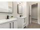 Modern bathroom featuring double sink, square mirrors and black fixtures at 17872 W Estes Way, Goodyear, AZ 85338