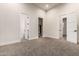 This bedroom features neutral walls, carpet floors, and multiple doors for easy access at 17872 W Estes Way, Goodyear, AZ 85338