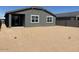 The rear exterior of the home features sliding glass doors and large windows at 20331 N 225Th Dr, Surprise, AZ 85387