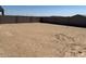 Spacious, dirt backyard surrounded by a privacy fence at 20331 N 225Th Dr, Surprise, AZ 85387