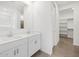 Bathroom featuring double sinks, an extra large mirror and a walk in closet at 20331 N 225Th Dr, Surprise, AZ 85387