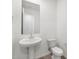 Bathroom featuring white vessel sink, white toilet, neutral paint color, and a framed mirror at 20331 N 225Th Dr, Surprise, AZ 85387