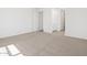 Bedroom featuring clean, tan carpet, neutral paint color, and a walk-in closet at 20331 N 225Th Dr, Surprise, AZ 85387