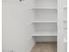 Well-organized walk-in closet with built-in shelves offering ample storage space for an efficient wardrobe at 20331 N 225Th Dr, Surprise, AZ 85387