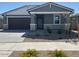 Charming single-story home featuring a stone accent facade and a two-car garage at 20331 N 225Th Dr, Surprise, AZ 85387