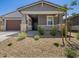 Charming single-story home featuring a two-car garage and well-maintained xeriscaped front yard at 20331 N 225Th Dr, Surprise, AZ 85387