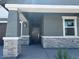 Inviting front porch with stone pillar accents at 20331 N 225Th Dr, Surprise, AZ 85387
