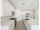 Bright modern kitchen boasts white cabinets, quartz countertops, stainless steel appliances, and a central island at 20331 N 225Th Dr, Surprise, AZ 85387