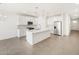 Modern, all white kitchen with an island, stainless steel appliances, tile flooring, and pendant lighting at 20331 N 225Th Dr, Surprise, AZ 85387