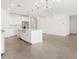 Open-concept kitchen featuring white cabinets, a center island, and stainless steel appliances at 20331 N 225Th Dr, Surprise, AZ 85387