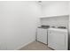 Laundry room featuring a washer and dryer, neutral paint color and a shelf at 20331 N 225Th Dr, Surprise, AZ 85387