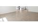 Open living area featuring neutral tile flooring and an easy flow to the kitchen at 20331 N 225Th Dr, Surprise, AZ 85387