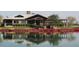 Scenic clubhouse view with meticulous landscaping and lakeside reflection, ideal for community gatherings at 4196 E Bonanza Rd, Gilbert, AZ 85297