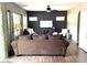 Cozy living room with hardwood floors, a ceiling fan, and an entertainment center at 4196 E Bonanza Rd, Gilbert, AZ 85297