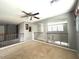 View of the carpeted living room upstairs, showcasing an iron railing and arched entryways at 4196 E Bonanza Rd, Gilbert, AZ 85297