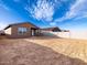 View of a backyard with dirt, block wall fence, and the rear of a single-story home at 4256 W Jeanette Ln, San Tan Valley, AZ 85144