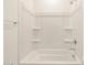 Clean white bathtub and shower combination with built-in shelving in bathroom at 4256 W Jeanette Ln, San Tan Valley, AZ 85144