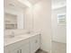 Bright bathroom features a double sink vanity, large mirror, and a window for natural light at 4256 W Jeanette Ln, San Tan Valley, AZ 85144